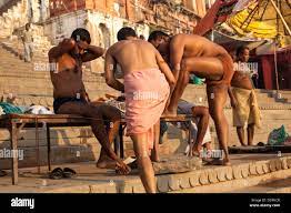 Indian men on the ghat after bathing, Varanasi, India Stock Photo 