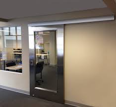 Sliding barn door separates the home office from the small bathroom from: Designing Office Space 4 Reasons To Say Yes To A Barn Door Kv Knape Vogt