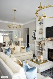 Small pops of gold in the picture frames stand out in this calming and soothing white space. Elegant Christmas Living Room Soft Blue Gold Silver White Citrineliving Bloglovi White Living Room Decor Gold Living Room Decor Blue Living Room Decor
