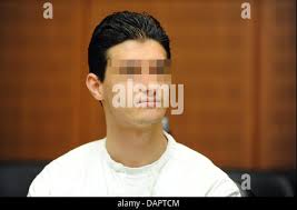 21-year old Arid Uka, center seen from behind, waits for the beginning of  his trial at a court in Frankfurt, Germany, Wednesday, Aug. 31, 2011.  Kosovo born Uka is accused of killing