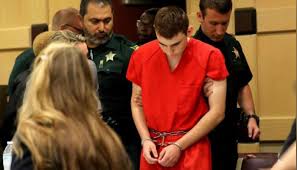 The suspect in the deadly shooting at a florida airport was charged saturday with an act of violence at an international airport resulting in death, according to a statement by the miami u.s. Head Bowed Florida Shooting Suspect Returns To Court For Hearing