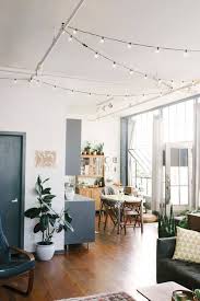 String lights across bedroom ceiling. 28 Ways To Use Those Magical String Lights Apartment Therapy