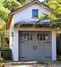The garage doors are set in white and glass, and are fitted with black iron details that give them a cool rustic look. 110 Detached Garages Ideas Garage Design Garages House Exterior
