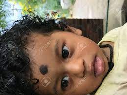 Indian Baby Boy With Black Curling Hair Starring At Something With Mouth Open Stock Photo Picture And Royalty Free Image Image 155948348