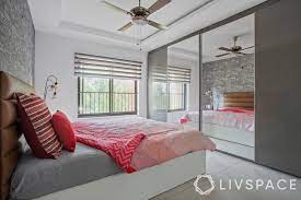 Floor to ceiling wardrobes with sliding doors is a splendid solution to utilize all the accessible space on your wall. These Indian Bedroom Cupboard Designs Are Perfect For Small Spaces