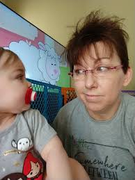 Grandbaby fixing your hair for a smile
