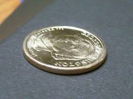 Two george washington $1 coins, edge view, showing opposite orientations of edge lettering. Washington Dollar Error Coins