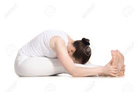 With both arms extended, the body bends toward the lead foot. Sporty Beautiful Young Woman In White Sportswear Sitting In Seated Forward Bend Pose Doing Paschimothanasana Caterpillar Yin Pose Studio Full Length Shot Isolated Stock Photo Picture And Royalty Free Image Image 42895865