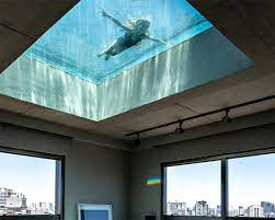 When space constraints or design prerequisites require that a pool goes above ground or on a roof, a natare stainless steel elevated pool is the answer. All Glass Swimming Pool Filters Sunlight Within Spacious Penthouse Renovation In Brazil