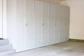 Learn how to build simple, cheap garage storage shelves that use the wasted space above your garage door! Garage Storage Cabinets Buildsomething Com