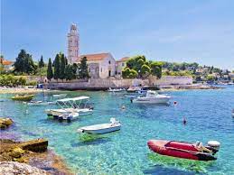 Two young women are laying at the pebble beach with panorama of mountains. Croatia S Sexiest Beaches Croatia Travelchannel Com Croatia Vacation Destinations Ideas And Guides Travelchannel Com Travel Channel