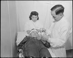 File:Minidoka Relocation Center. Doctor Robert H. Shiomi, Miyoko Shitamae,  nurse, Jimmie Shimizu, patien . . . - NARA - 536596.jpg - Wikimedia Commons