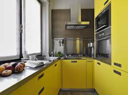 This is a simple and homey kitchen with a sunny demeanor thanks to its yellow walls complemented by the yellow lights for additional warmth. 50 Yellow Kitchen Ideas Photos Home Stratosphere