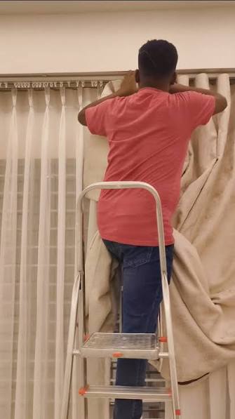 Plumstead fitter assembling a flat-pack curtain rail before mounting