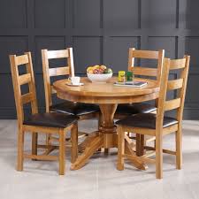 Modestly sized and elegantly designed, these 4 seater dining table and chairs are ideal for any sized outdoor space. Solid Oak Round 4 Seater Dining Table 4 Ladder Back Oak Chairs The Furniture Market