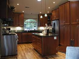 #kitchen features tiled floors and stainless steel appliances. I Would Love To Have This Kitchen Brown Kitchen Cabinets Dark Brown Kitchen Cabinets Kitchen Cabinets Pictures