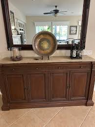 I want to paint this credenza white but leave the top as is in dark brown  wood stain. What do you think? My puppy chewed a part of the edge