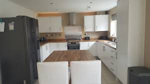 What wall colors will you want to go with the cabinets? Symphony White Gloss Kitchen With Laminate Oak Block Worktops Kitchen White Gloss Kitchen New Kitchen