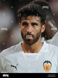 Eray Comert of Valencia CF (L), De Burgos Bengoetxea referee (C) and Javier  Guerra of Valencia CF (R) in action during the Headline: La Liga Santander  Regular Season Round 35