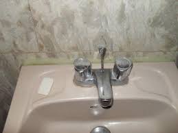 bathroom sink with water stains, caulk