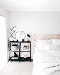 Modern Minimal Bedroom Design Featuring A Bleached Wood Headboard White Bedding Black Metal And Glass Shelves As A Bedside Table Home Bedroom Home Interior