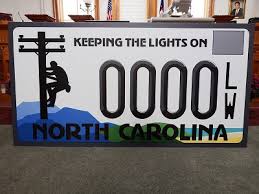 The plate had blue embossed characters over a reflective white background. New Nc Specialty License Plate Design Revealed At Event In New Bern Wnct