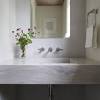 Classic carrera marble bathrooms with floating sinks. 3