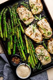 Baked Boneless Pork Chop And Asparagus Sheet Pan The Modern Proper Recipe Baked Boneless Pork Chops Boneless Pork Pork Chop Recipes Baked