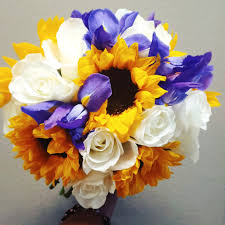 Blue and yellow is one of the wedding color combos that'll never go out of style, as evidenced by this blue wedding cake with yellow floral accents. Sunflower Bridal Bouquet By Jatcoia Floral Design