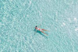 9 Ways To Protect Your Skin And Hair From Chlorine Floating Photos Pool Captions Swimming