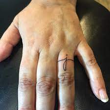 Ever Wanted To Honor Your Partner With Something More Permanent Here S The Best Wedding Ring Ta Wedding Finger Tattoos Wedding Band Tattoo Wedding Ring Tattoo