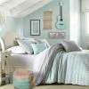 Turquoise blue walls with ornate black print bed covers, lovely mirrors and black chandelier. 1