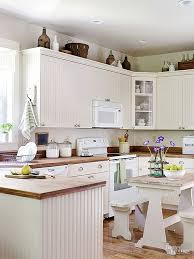 Beaded Board Cabinets And Weathered Wood Countertops Set The Stage For This Vin Decorating Above Kitchen Cabinets Above Kitchen Cabinets Kitchen Cabinets Decor