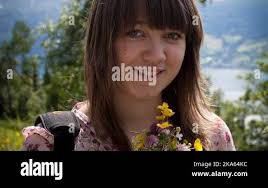 In this July 19, 2011 photo, attached by rope to a waiting helicopter,  researcher Carl Gladish walks back after deploying a GPS seismometer, or  GeoPebble, to track glacial movement