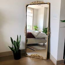 A metal support flips out from the back of the mirror, allowing it to stand on its own in any corner of your room. How To Turn A 50 Ikea Mirror Into An Anthropologie Look Alike Apartment Therapy