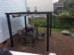 Pergola From Home Depot Anchored Into Concrete Pavers Buried Under The Gravel Patio Pergola Pergola With Roof Pergola Garden