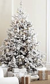 A White Christmas Tree Is Fresh And Contemporary To Match A Modern Decor Holi White Christmas Tree Decorations Flocked Christmas Trees White Christmas Decor