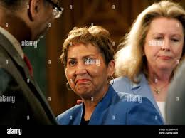 Carol Blocker, whose daughter took her own life after battling postpartum  depression, center, looks toward Rep. Bobby Rush, D-Ill., left, as Susan  Stone, right, president of Postpartum Support International, looks on,  during