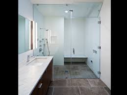 A small modern bathroom outfitted with white subway tile and gray penny tile could look pretty plain, but an interesting country sink and round galvanized mirror add an unexpected touch. Home Creative Construction Remodeling Inc