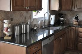 Many of the options of granite for oak cabinets include speckles or veins that are a similar shade to the oak. Uba Tuba Granite Countertops Pictures Cost Pros Cons