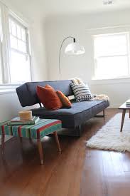 Coffee cup and gray midcentury loveseat. Mid Century Modern Arc Lamp And Mexican Blanket Ottoman Eklektisch Wohnbereich Los Angeles Von Madison Modern Home