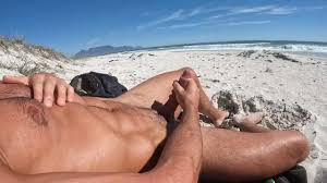 Muscle lad wanks on the beach with a view