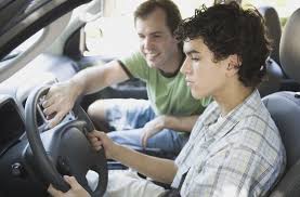 A mentor teaching the youth how to drive
