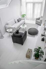Tufted detailing on the grey sofa is carried through to the. White And Grey Apartment Design In Delft