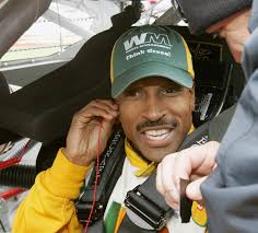 A black driver receiving the traditional kiss from the event's beauty queen in. Bill Lester Returning To A More Welcoming Diverse Nascar