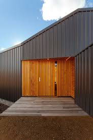This Rural Tasmanian House Has A Terrace Piercing Its Middle Industrial House Exterior Architecture Exterior Architecture