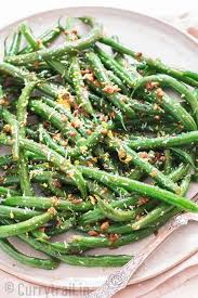 Garlic Sauteed Green Beans Sprinkled With Parmesan And Lemon Zest Thanksgiving Side Dish On White Ceramic Plate Sauteed Green Beans Green Beans Sauteed Greens