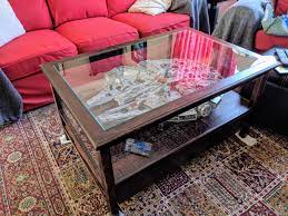 It is a wooden coffee table with 2 beveled glass inserts on the top. Glass Top Coffee Table For My Lego Millennium Falcon Pics