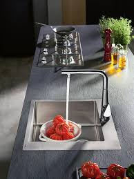 A spacious round pine wood table top perched atop a utilitarian steel frame creates a convenient place for holding food and drinks while the height adjustable footrest provides a comfortable spot to rest your feet. Create An Industrial Style Kitchen Hansgrohe Int