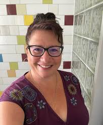 This is what 46 looks. Happy birthday to me. 🥳 Photo description for  anyone who needs it. It's me! In my garden with greenery behind me. I'm  wearing new make up I